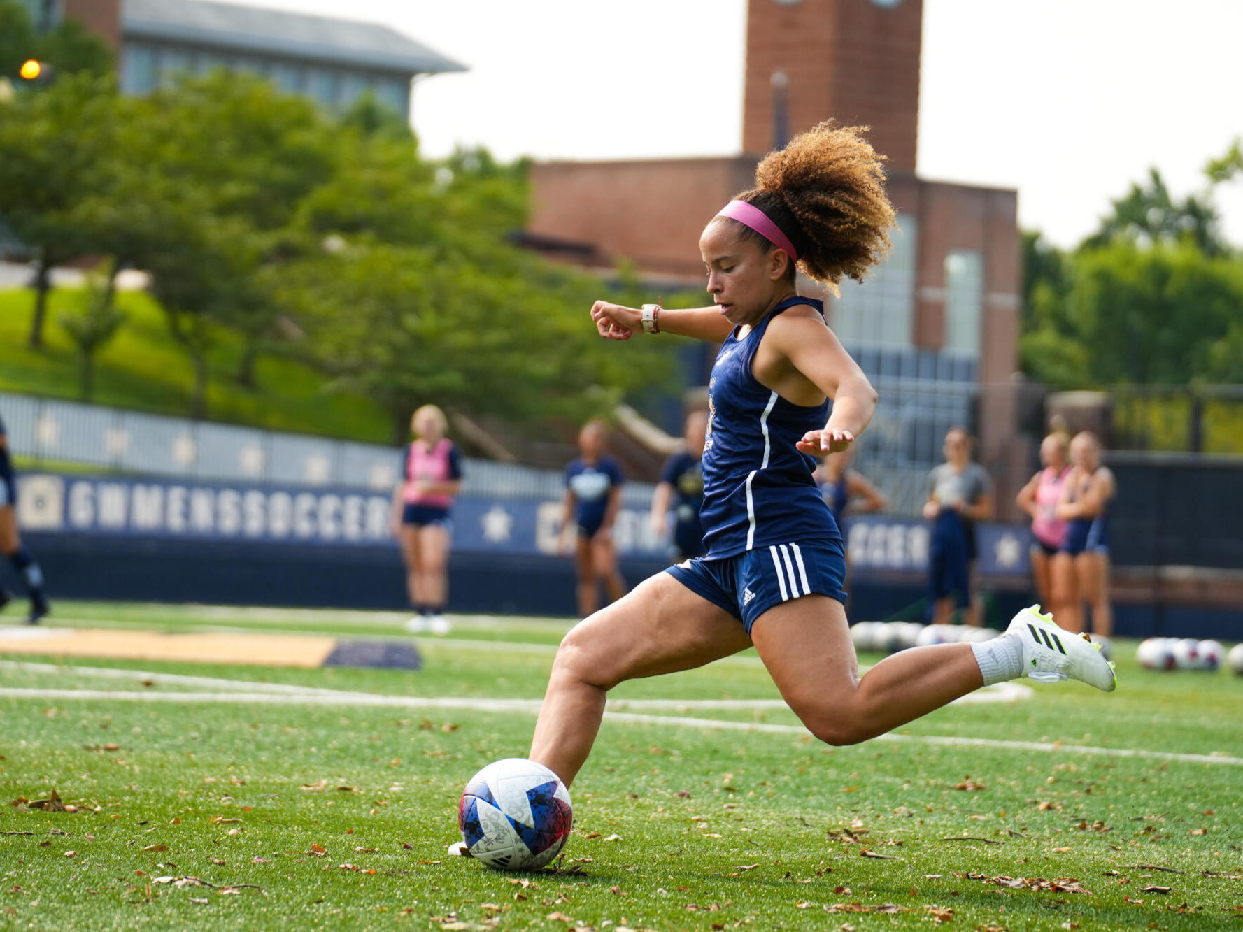 Avril Silva pictured about to kick a soccer ball to the left wearing navy blue